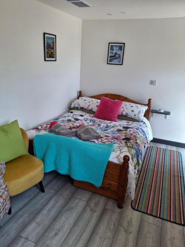 a bedroom with a bed and a chair at Little Pedn in Penzance
