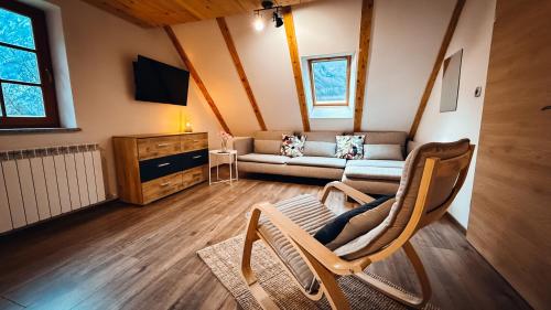 a living room with a couch and a tv at Apartments Mala Korita Soče in Soča