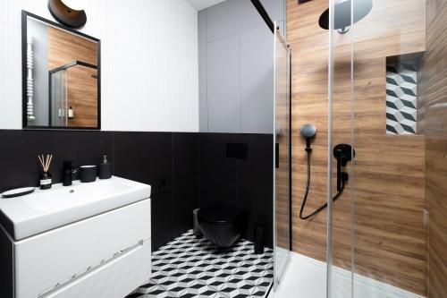 a bathroom with a sink and a shower at Apartamenty Rocha in Pabianice