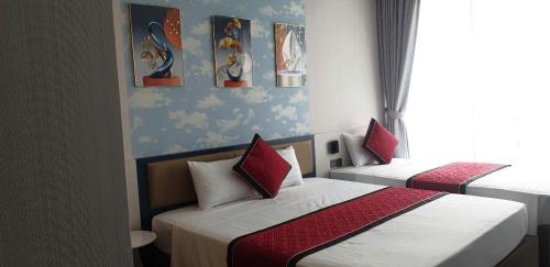 Hoằng HóaFlamingo Ibiza Hải Tiến 1723-1725的有两张床和一扇窗户的卧室