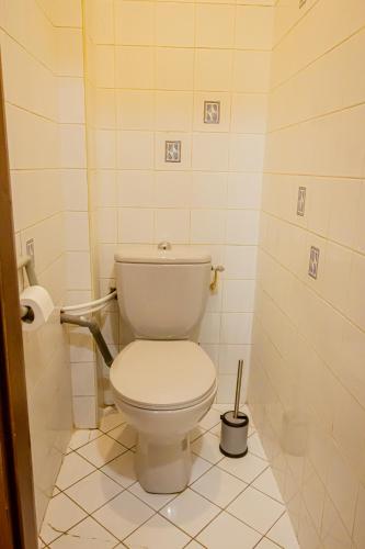 a bathroom with a white toilet in a stall at Albert 1er in Albertville