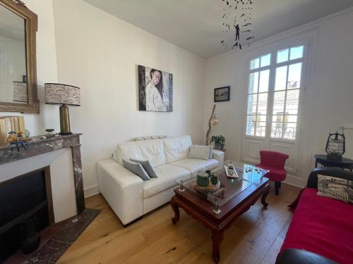 un salon avec un canapé blanc et une table dans l'établissement Le Duplex de Saint Jacques, à Dieppe