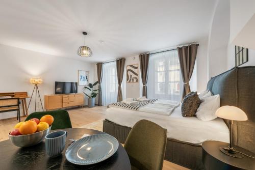 a bedroom with a bed and a table with a bowl of fruit at Modern Housing Apartments in Vienna