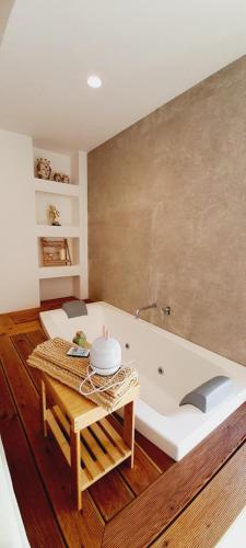 a bath tub in a room with a table at BARBARA Classy Apartments 103, Wellness in Siracusa