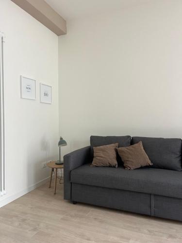 a living room with a gray couch and a table at AL 31 Bg in Bergamo