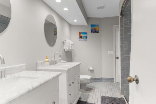 a white bathroom with a sink and a toilet at Candida's Retreat in Spring Hill