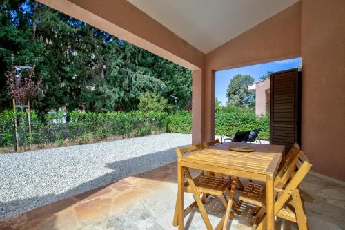 a dining room with a table and chairs and a large window at Aphrodite Gardens Modern Villas by VICHY Holidays in Paphos