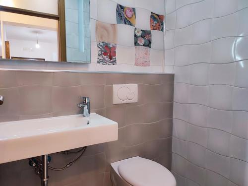 a bathroom with a sink and a toilet at Talia apartments & pool in Dobra Voda