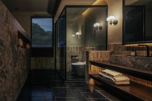 a bathroom with a sink and a toilet at Jingdezhen Xingshan City outside Jielu Hotel in Jingdezhen