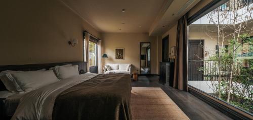 a bedroom with a bed and a large window at Jingdezhen Xingshan City outside Jielu Hotel in Jingdezhen