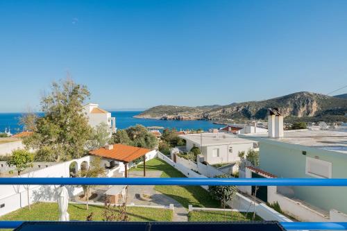 a view of the ocean from the balcony of a building at Elegant Coastal Retreat, Jacuzzi and Sea Views By KB Hospitality in Dhaskalión