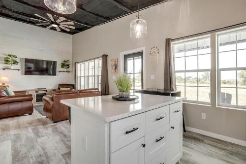 a kitchen with a white island in a living room at Unique Barn by the Lake in Bridgeport, Texas in Runaway Bay