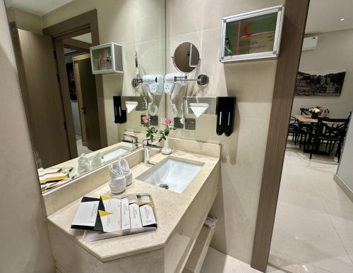 a bathroom with a sink and a large mirror at Mehad Stay for Self Check-In Apartment in Jeddah