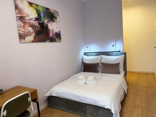 a bedroom with a bed with two shoes on it at Apartment Targowa L7 in Lublin