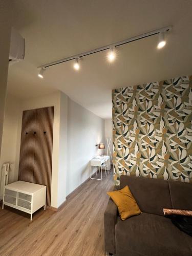 a living room with a couch and a wall at La casa di Cri - Moncalieri in Moncalieri