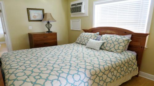 a bedroom with a bed and a window at Steps From Beach! Grill - Wif in Holmes Beach