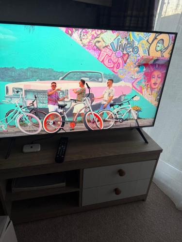 a flat screen tv sitting on top of a dresser at Agnes Place in Nairn