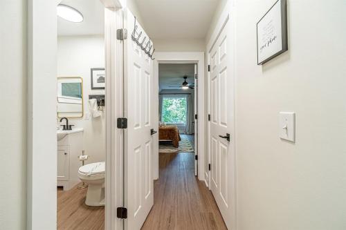 a white bathroom with a toilet and a sink at Lovely Secluded Cabin Surrounded by Trees in Clarkesville, Georgia in Aerial