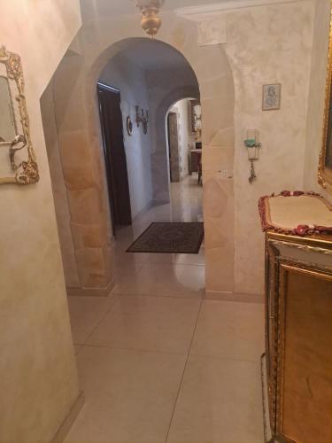 a hallway with an archway in a house at Luxury House in Catania