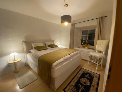 a bedroom with a bed and a window and a chair at Ferienwohnung Silvia in Villingen-Schwenningen