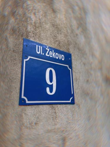 a sign on a wall with the number nine at Apartments Tijana in Tivat