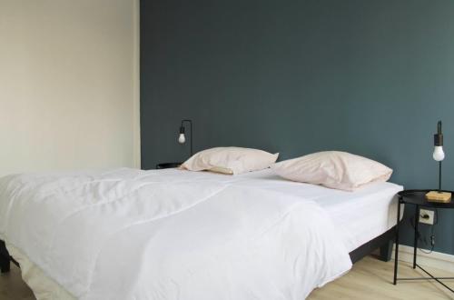 un lit blanc avec deux oreillers dessus dans l'établissement Superb apartment 1BR 4P - Etoiles Ternes, à Paris