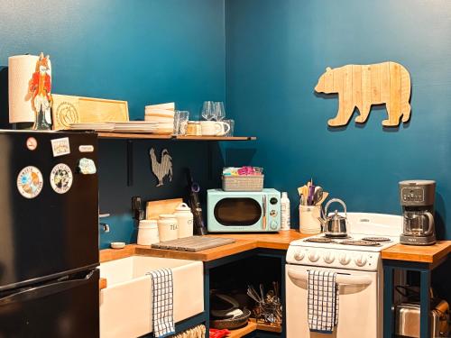 a kitchen with a black refrigerator and a microwave at Letchworth Farm Guesthouses in Nunda