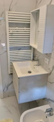 a bathroom with a sink and a toilet and a mirror at B&B Diana in Bologna