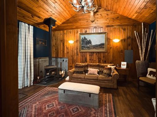 a living room with a couch and a fireplace at Letchworth Farm Guesthouses in Nunda