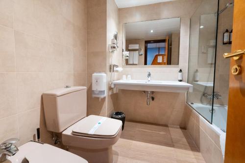 a bathroom with a toilet and a sink at Estela Barcelona in Sitges