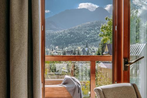 a window with a view of a mountain at Tatra Resort & SPA in Kościelisko