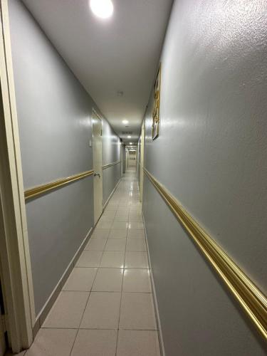a long hallway with a long white corridor at SS Grey Hotel Bukit Bintang in Kuala Lumpur
