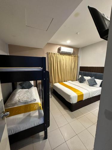 a bedroom with two bunk beds and a window at SS Grey Hotel Bukit Bintang in Kuala Lumpur