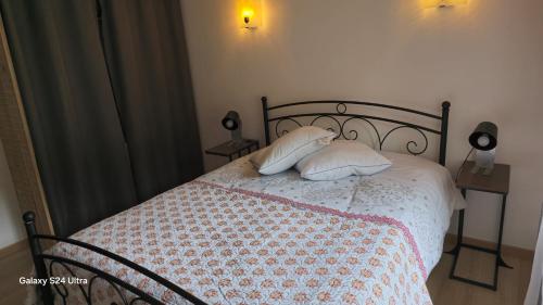 a bedroom with a bed with two pillows on it at le refuge des sapins in Provenchères-sur-Fave