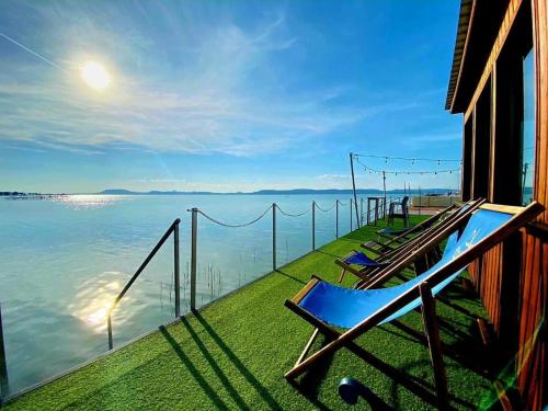 a balcony of a house with a view of the water at BL Yacht Club A III58 in Balatonlelle