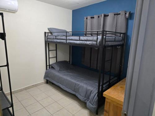 a bedroom with two bunk beds in a room at Blue House - Sleeps 5 - Near Hermosa Beach in Puerto Peñasco