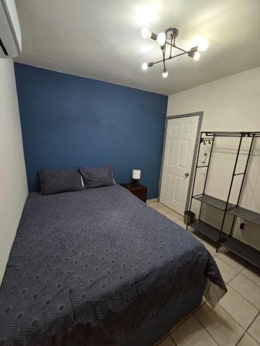 a bedroom with a bed and a blue wall at Blue House - Sleeps 5 - Near Hermosa Beach in Puerto Peñasco
