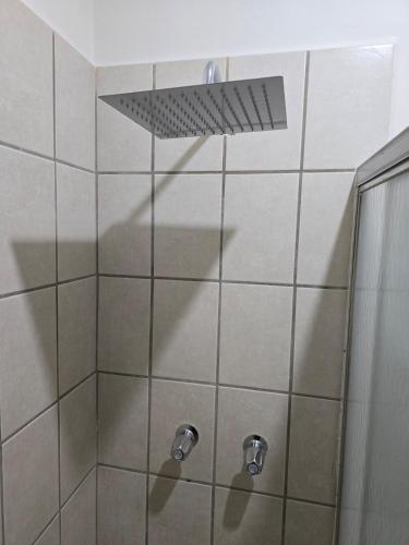 a shower with a shower head in a bathroom at Blue House - Sleeps 5 - Near Hermosa Beach in Puerto Peñasco