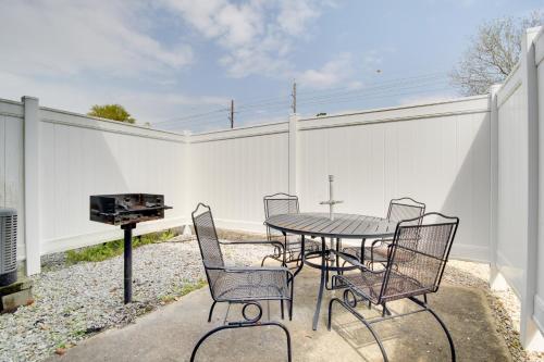 a patio with a table and chairs and a grill at Less Than Half Mi to Gulf Biloxi Condo with Patio! in Biloxi