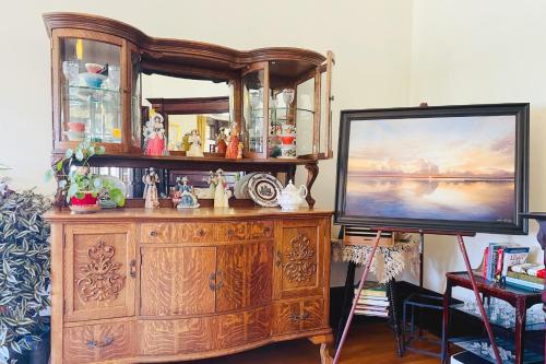 a large wooden entertainment center with a flat screen tv at The Eden Hall Inn in Charlottetown
