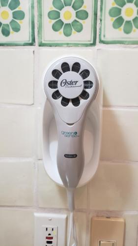 a hair dryer on a urinal in a bathroom at Casa Colonial Cozumel, Villa Mango in Cozumel