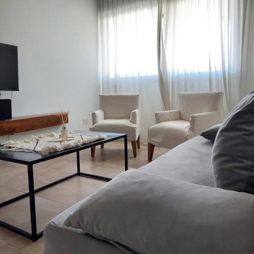 a living room with a couch and chairs and a coffee table at Rentarte in Pilar