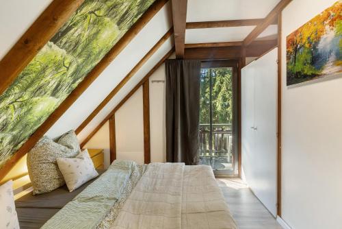 a bedroom with a bed and a large window at Ferienhaus Rotkäppchen in Frankenau
