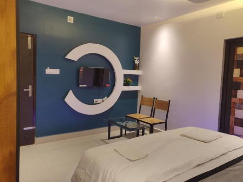 a bedroom with a c sign on a blue wall at Ls palace in Bhubaneshwar
