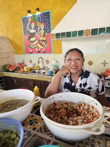 a woman sitting at a table with a bowl of food at Casa Colonial Cozumel, Villa Mango in Cozumel