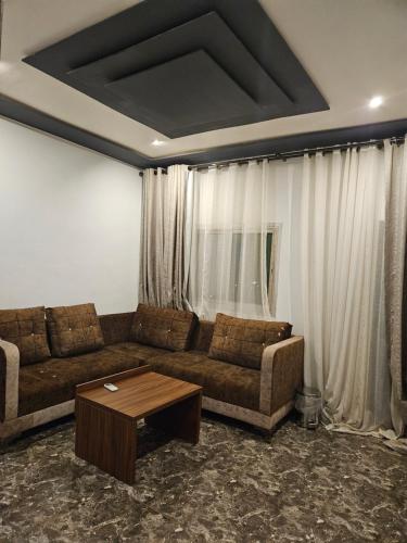 a living room with a couch and a coffee table at Le conrad grand luxury hotel in Yaoundé