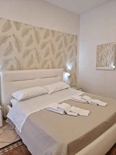 a bedroom with a bed with two towels on it at B&B Enjoy Pompeii Ruins and Church in Pompei