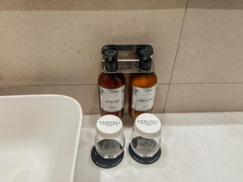 a bottle of honey and two measuring cups on a counter at Osmanli Cappadocia Hotel in Goreme
