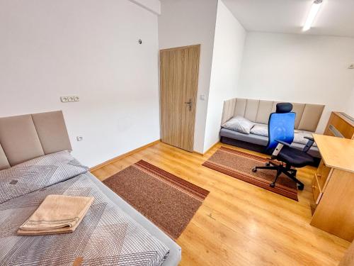 a bedroom with a bed and a desk and a chair at Penzión Oliver Humenné in Humenné