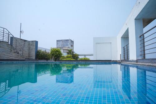 a swimming pool in a building at Siddha Xanadu,New Town, kolkata Airport & CC2, One Room Apartment in kolkata